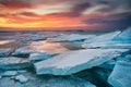 Winter landscape on seashore during sunset. Lofoten islands, Norway. Ice and sunset sky.