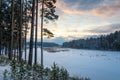 Winter landscape on the shore of the frozen river in the evening, Russia, Ural Royalty Free Stock Photo