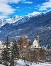 Winter landscape with small Church Reformierte Kirche Scuol in front of the mountains, Scuol , Lower Engadine, Switzerland Royalty Free Stock Photo