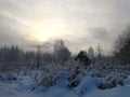 Winter landscape with small house in snowy field. Royalty Free Stock Photo