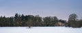 Winter landscape in snow with bare trees and country manor house. Royalty Free Stock Photo