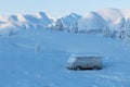 Winter landscape with a snow-covered car standing among the mountains in Yakutia, Sakha Republic