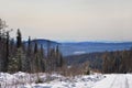 Winter landscape with snow covered forest and mountains. Eastern Sayan Mountains in Siberia, Russia. Royalty Free Stock Photo