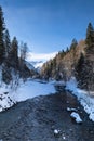 Winter landscape with snow-covered forests and a boulder-strewn river Royalty Free Stock Photo