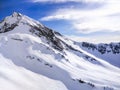 Winter landscape. Snow covered high mountain peaks under cloudy panoramic skies in Europe. Royalty Free Stock Photo