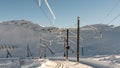 Winter landscape of snow covered railway station with background of snowcapped mountains and blue sky. Rochers de Naye, Royalty Free Stock Photo