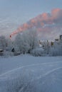 Winter landscape, snow-covered trees, residential houses. Chimney with puffs of smoke. Day during the polar night. Royalty Free Stock Photo