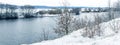 Winter landscape with snow-covered trees on the river bank, panorama Royalty Free Stock Photo