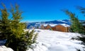 Winter landscape with snow, wooden houses and clear blue sky, Trikala Korinthias.