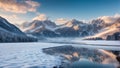 Winter landscape with snowcapped mountains and frozen lake