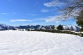 Winter landscape with snowy field, mountains and stone wall. Trees and blue sky, Piornedo, Lugo, Spain. Royalty Free Stock Photo