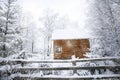 Winter landscape with snowy fir trees and mountain cottage Royalty Free Stock Photo