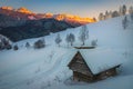 Winter landscape with snowy hut and high mountains at sunset Royalty Free Stock Photo