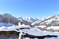 Winter landscape with snowy mountains and valley with forest with blue sky. View from wooden fence covered with snow. Lugo, Spain. Royalty Free Stock Photo