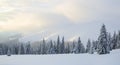 Winter landscape. Spectacular panorama is opened on mountains, trees covered with white snow, lawn and blue sky with clouds Royalty Free Stock Photo