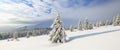 Winter landscape. Spectacular panorama is opened on mountains, trees covered with white snow, lawn and blue sky with clouds Royalty Free Stock Photo