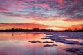 Winter landscape with sunset fiery sky.