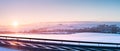 Winter landscape, sunset over the hills near the national road Royalty Free Stock Photo