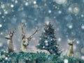 Winter landscape with three bronze deers, snow and fir tree. Royalty Free Stock Photo