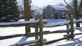 Winter landscape of Victorian-style house exterior in a Canadian village with wooden post fences Royalty Free Stock Photo