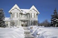 Winter landscape of Victorian-style house exterior with deep snow in winter Royalty Free Stock Photo