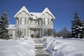 Winter landscape of Victorian-style house exterior with deep snow in winter Royalty Free Stock Photo