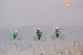 Winter landscape - view of the bike zip line with cyclists above the winter mountain forest during a snowfall, Bukovel ski resort,