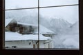 Winter landscape  view of the mountains outside the window. Winter Alps in fog and houses. Picture for background Royalty Free Stock Photo