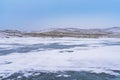 Winter landscape. View from Ogoy Island to Olkhon and frozen Lake Baikal on a cloudy day Royalty Free Stock Photo