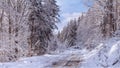 View of the snowy road in the winter mountain forest after snowfall Royalty Free Stock Photo