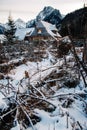 Winter landscape of a wooden house on a background of snow-covered forest and mountains. Place for text or advertising Royalty Free Stock Photo