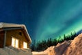 Winter landscape with wooden house under a beautiful starry sky Royalty Free Stock Photo