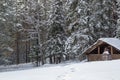 Winter landscape. Wooden hut in the middle of a snowy forest Royalty Free Stock Photo