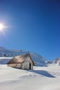 Winter landscape with wooden toolshed at Balea lake, Sibiu county, Romania.