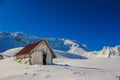 Winter landscape with wooden toolshed at Balea lake, Sibiu county, Romania. Royalty Free Stock Photo