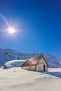 Winter landscape with wooden toolshed at Balea lake, Sibiu county, Romania.