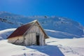 Winter landscape with wooden toolshed at Balea lake, Sibiu county, Romania.