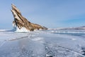Winter landscape, cracked frozen lake with beautiful mountain island on frozen lake Baikal in Siberia, Russia Royalty Free Stock Photo
