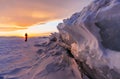Winter landscape in sunset, Cracked frozen ice of lake covered by snow at lake Baikal, Russia in sunset Royalty Free Stock Photo