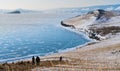 Winter landscape, tourist trekking on the island at frozen lake Baikal in Siberia, Russia