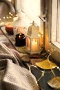 Winter lanterns decorations at window,cosy home interior decoration with candles