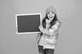 Winter leisure. Smiling girl wear winter outfit show blank chalkboard copy space. Winter event. Informing kids community