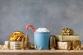 Winter lifestyle with cup of hot cocoa with marshmallows and Christmas gift or present boxes and holiday decorations. Royalty Free Stock Photo