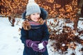 Winter lifestyle portrait of happy kid girl playing snowballs on the walk Royalty Free Stock Photo