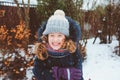 winter lifestyle portrait of happy kid girl playing snowballs on the walk Royalty Free Stock Photo