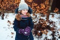 Winter lifestyle portrait of happy kid girl playing snowballs on the walk Royalty Free Stock Photo