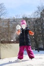 Winter games - a little girl throws a snowball