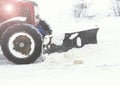 Winter, a lot of snow. The tractor clears the snow. Royalty Free Stock Photo