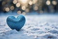 Winter love symbol Blue heart on snow with bokeh background Royalty Free Stock Photo