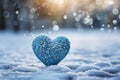 Winter love symbol Blue heart on snow with bokeh background Royalty Free Stock Photo